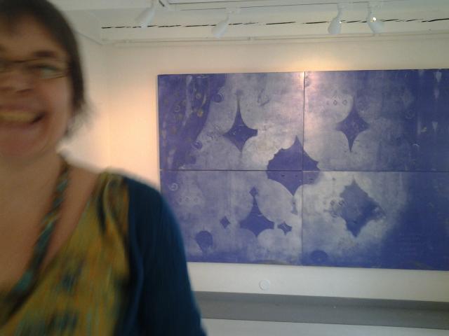 Artist Hanna Holma in front of a painting