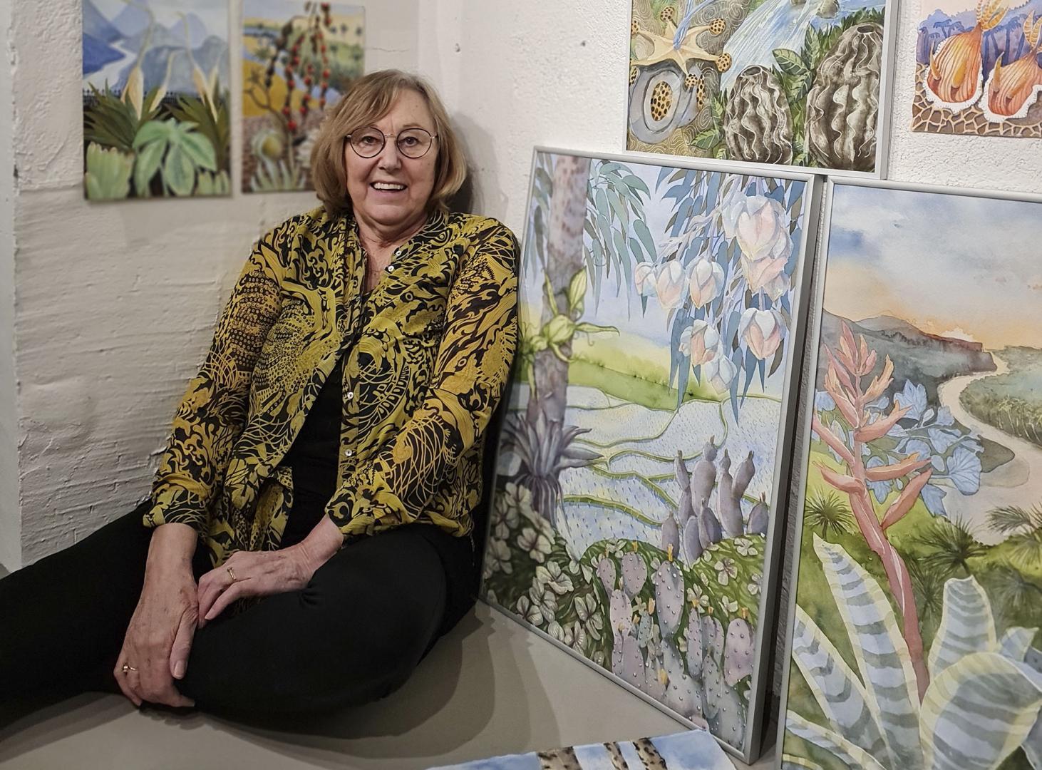 Berit Olander, woman sitting on the floor next to paintings