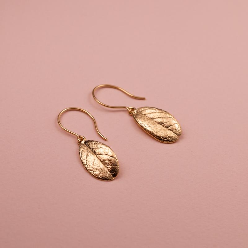 Eternal Lingon örhängen i guld, skapade från äkta lingonblad / Eternal Lingon - korvakorut kullasta, valmistettu aidoista puolukanlehdistä / Eternal Lingon earrings in gold, made from real lingonberry leaves.